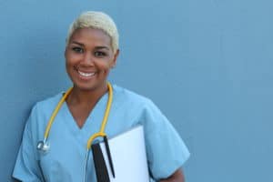 A black nurse smiles