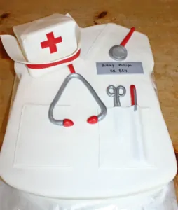 A cake designed to look like white nurse scrubs